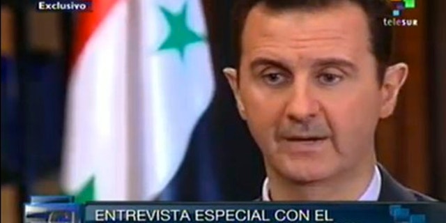 Sept. 25, 2013: In this frame grab taken from online video broadcast on Telesur television, Syria's President Bashar Assad speaks during an interview with a Telesur reporter in Damascus, Syria.
