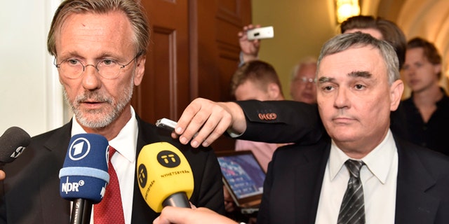 July 16, 2014: Julian Assange's lawyers Tomas Olsson, left, and Per E. Samuelsson talk to media prior to a public court hearing in Stockholm.