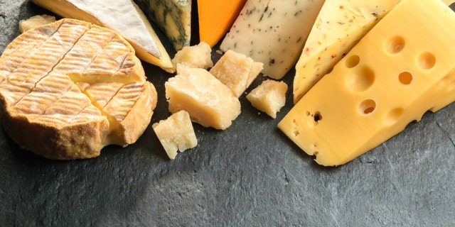 Various types of cheese with empty space background