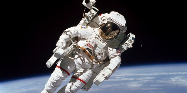 File Feb. 7, 1984: Astronaut Bruce McCandless participates in a spacewalk a few meters away from the cabin of the Earth-orbiting space shuttle Challenger, using a nitrogen-propelled Manned Maneuvering Unit.