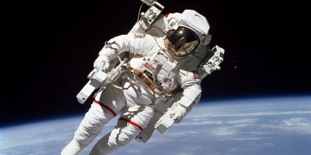 File Feb. 7, 1984: Astronaut Bruce McCandless participates in a spacewalk a few meters away from the cabin of the Earth-orbiting space shuttle Challenger, using a nitrogen-propelled Manned Maneuvering Unit.