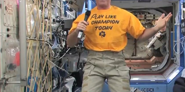 NASA astronaut Kevin Ford smiles while wearing his Notre Dame "Play Like a Champion Today" shirt on Dec. 26 to support the college's BCS Championship Game against Alabama on Jan. 7, 2013. Ford is the commander of Expedition 34 aboard the Intern
