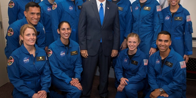 U.S. Vice President Mike Pence poses for a group photograph with NASA's 12 new astronaut candidates at NASAs Johnson Space Center in Houston, Texas, U.S., June 7, 2017. NASA astronaut candidates, standing from L-R, Robb Kulin, Jonathan Kim, Robert Hines, Warren Hoburg, Matthew Dominick, Kayla Barron, Jessica Watkins, from L-R kneeling, Francisco Rubio, Loral OHara, Jasmin Moghbeli, Zena Cardman, and Raja Chari. (Bill Ingalls/Courtesy NASA/Handout via REUTERS)