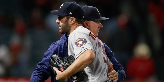 Houston Astros starting pitcher Justin Verlander gets a pack on the back from manager A.J. Hinch after the team's 2-0 win over the Los Angeles Angels in a baseball game Wednesday, May 16, 2018, in Anaheim, Calif.