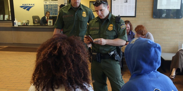 DEPEW, NY - JUNE 05:  U.S. Border Patrol agents check passenger identifications at a train station on June 5, 2013 in Depew, New York. The agents set up a 24 hour check of transportation hubs in and around Buffalo. They said they received intelligence of undocumented immigrants passing through the area. The Border Patrol also monitors cross border traffic along the northern border between the United States and Canada.  (Photo by John Moore/Getty Images)