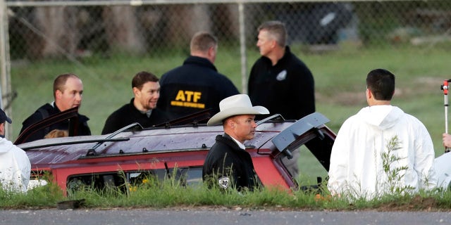 Officials investigate the scene where a suspect in a series of bombing attacks in Austin blew himself up as authorities closed in, Wednesday, March 21, 2018, in Round Rock, Texas.