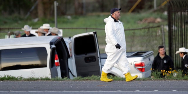 Officials investigate the scene where a suspect in a series of bombing attacks in Austin blew himself up as authorities closed in, Wednesday, March 21, 2018, in Round Rock, Texas