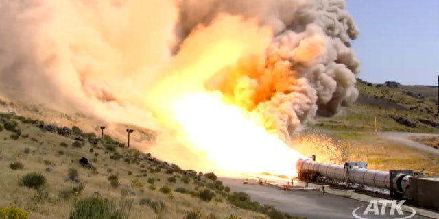 This still from an ATK webcast shows a side view of the five-segment solid rocket booster DM3 during a Sept. 8, 2011 static test firing at the company's motor proving grounds near Promontory, Utah.