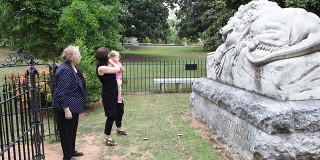 July 18, 2014: Janice Reed, her daughter Nancy Reed Morris, and her granddaughter Megan Morris, from left, visit the Confederate unknown soldier monument at Historic Oakland Cemetery while taking a Battle of Atlanta mobile app tour in Atlanta.