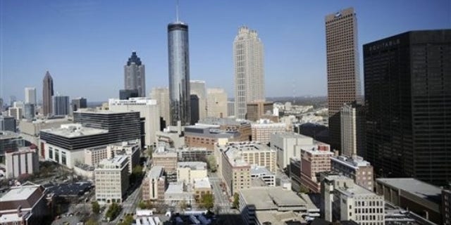 The Atlanta skyline is shown Thursday, March 17, 2011. According to census data released Thursday Atlanta's population slowed over the last 10 years with the city adding only 1 percent as people fled to the suburbs seeking better schools, cheaper homes and safer neighborhoods. (AP Photo/Mike Stewart)