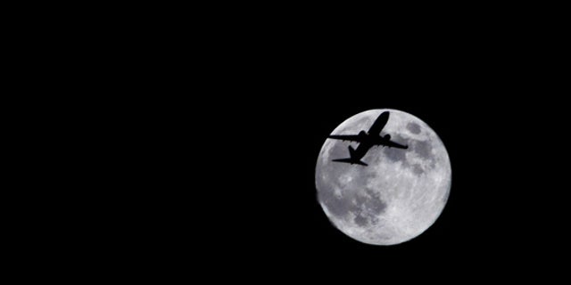 Photographer Sid Vedula captured this amazing view of the full moon of Aug. 1, 2012, from Houston, TX, with a passing airplane in silhouette.