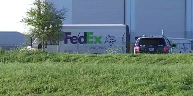 Authorities respond to a suspicious package at a FedEx facility in Austin on Tuesday.