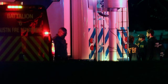 Officials work at the scene early Wednesday, March 21, 2018, in the Austin suburb of Round Rock, Texas, where according to authorities the suspect in a spate of bombing attacks that have terrorized Austin over the past month blew himself up with an explosive device as authorities closed in. (AP Photo/Eric Gay)