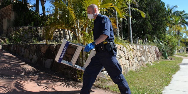 Sept. 18, 2014: A police officer searches a house in Mount Gravatt, Brisbane, Australia
