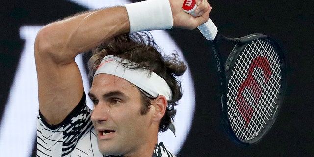 Switzerland's Roger Federer follows through on a forehand to Spain's Rafael Nadal during the men's singles final at the Australian Open tennis championships in Melbourne, Australia, Sunday, Jan. 29, 2017.