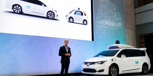 John Krafcik, CEO of Waymo Inc., the autonomous vehicle company created by Google's parent company, introduces a Chrysler Pacifica hybrid outfitted with Waymo's own suite of sensors and radar at the North American International Auto Show in Detroit, Sunday, Jan. 8, 2017. (AP Photo/Paul Sancya)
