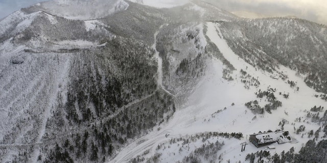 A cable car station, where skiers were awaiting rescue, and the volcano that erupted in the Kusatsu-Shirane mountains are seen from a Kyodo News helicopter in the Gunma Prefecture, northwest of Tokyo, Japan January 23, 2018.