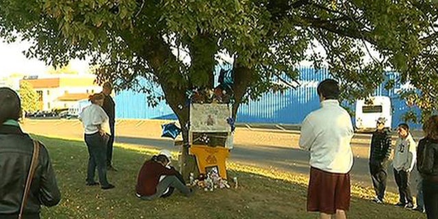 Oct. 27, 2013: Visitors gather around a memorial for Christopher Avlevo, who was killed in Philadelphia Saturday while trying to steer a pickup truck to safety after his stepfather blacked out behind the wheel.