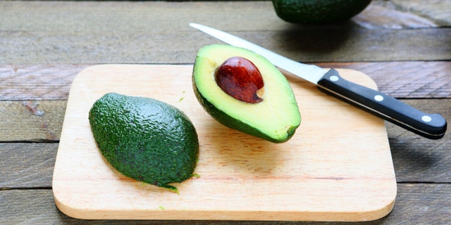 sliced ââavocado on a blackboard, food closeup