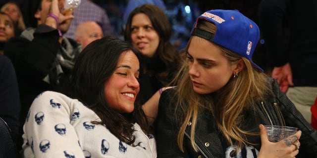 NEW YORK, NY - JANUARY 07:  Actress Michelle Rodriguez sits with with model Cara Delevingne during the game between the New York Knicks and the Detroit Pistons at  Madison Square Garden on January 7, 2014 in New York City.  NOTE TO USER: User expressly acknowledges and agrees that, by downloading and/or using this photograph, user is consenting to the terms and conditions of the Getty Images License Agreement. (Photo by Al Bello/Getty Images)