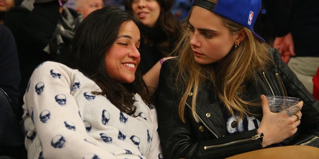 NEW YORK, NY - JANUARY 07: Actress Michelle Rodriguez sits with with model Cara Delevingne during the game between the New York Knicks and the Detroit Pistons at Madison Square Garden on January 7, 2014 in New York City. NOTE TO USER: User expressly acknowledges and agrees that, by downloading and/or using this photograph, user is consenting to the terms and conditions of the Getty Images License Agreement. (Photo by Al Bello/Getty Images)