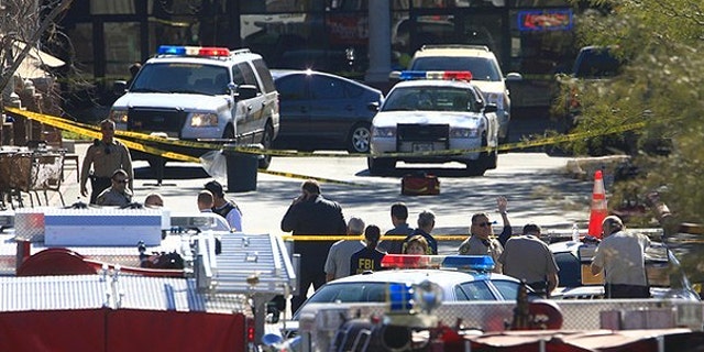 Jan. 8: Law enforcement personnel work a crime scene where U.S Representative Gabrielle Giffords (D-AZ) was shot along with others at a Safeway in Tucson, Arizona.