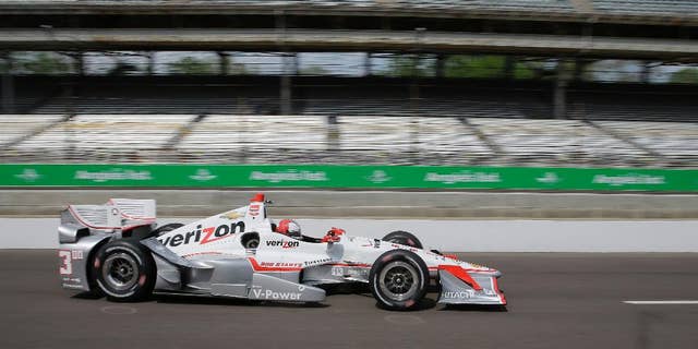 Helio Castroneves, of Brazil, drives down pit road during practice for the Grand Prix of Indianapolis auto race at the Indianapolis Motor Speedway in Indianapolis, Friday, May 8, 2015. (AP Photo/Darron Cummings)
