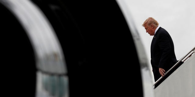 President Donald Trump steps from Air Force One as he arrives in West Palm Beach, Florida, December 9, 2017.