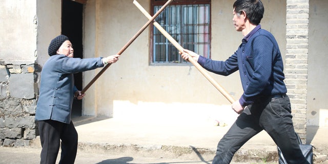 Zhang Hexian, left, practicing Kung Fu.