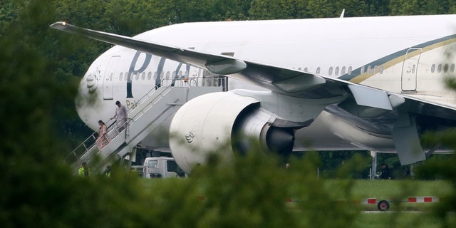 May 24, 2013 - Passengers disembark from Pakistan International Airlines flight PK709 bound for Manchester from Lahore, Pakistan, after it was diverted to Stansted Airport, north of London, England.