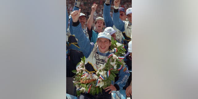 FILE - In this May 28, 1995 file photo, Jacques Villeneuve celebrates in Victory Lane after winning the Indianapolis 500 auto race in Indianapolis. Villeneuve is expected to finally compete for a second Indianapolis 500 crown. On Wednesday, Feb. 26, 2014, the 42-year-old Canadian driver is expected to be announced as a driver for Schmidt Peterson Motorsports this May. (AP Photo/Al Behrman, File)
