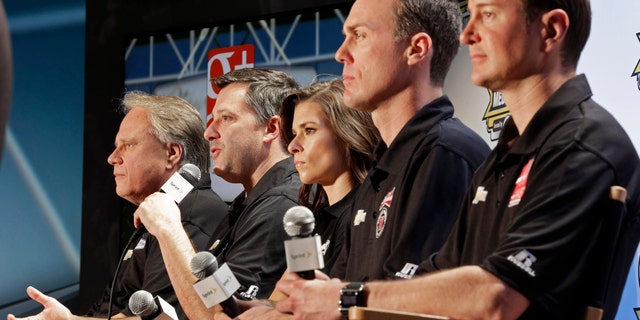 Driver/owner Tony Stewart, second from left, speaks as co-owner Gene Haas, left, and drivers, from right, Kurt Busch, Kevin Harvick and Danica Patrick listen during a news conference at the NASCAR Sprint Cup auto racing Media Tour in Charlotte, N.C., Monday, Jan. 27, 2014. (AP Photo/Chuck Burton)