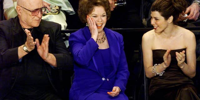 Sitting with Rod Steiger and Shirley Temple Black during the 70th annual Academy Awards.