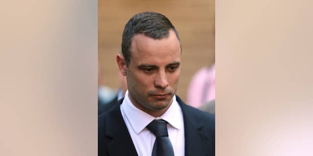 Oscar Pistorius leaves the high court in Pretoria, South Africa, Wednesday, May 14, 2014. The judge overseeing the murder trial of Pistorius on Wednesday ordered the double-amputee athlete to undergo psychiatric tests, meaning that the trial proceedings will be delayed. (AP Photo/Themba Hadebe)
