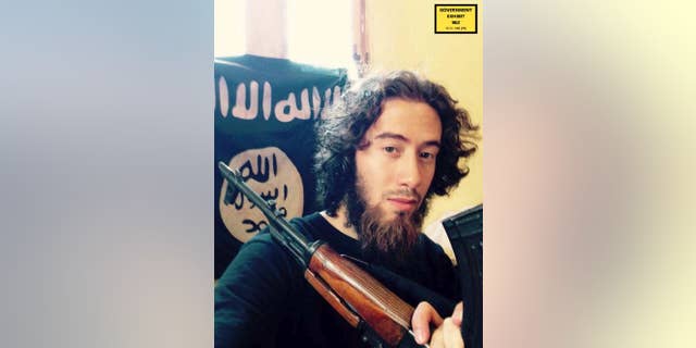 In this undated photo provided by the United States Attorney for the Southern District of New York, Samy el-Goarany poses for a photo with a weapon and the Islamic State group flag. Prosecutors showed this photo of Samy el-Goarany in federal court Tuesday, Jan. 17, 2017, during the trail of Ahmed Mohammed el-Gammal who is accused of helping Samy el-Goarany reach Syria where he trained with the Islamic State group before he was killed. The photo was shown while Samy el-Goarany's brother, Tarek el-Goarany, was testifying. (U.S. Attorney's Office for the Southern Distirct of New York via AP)