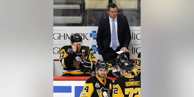 Pittsburgh Penguins' Sidney Crosby (87) sits on the bench with head coach Mike Sullivan behind him during the third period of Game 6 in an NHL Stanley Cup Eastern Conference semifinal hockey game against the Washington Capitals in Pittsburgh, Monday, May 8, 2017. The Capitals won 5-2 to force a Game 7. (AP Photo/Gene J. Puskar)