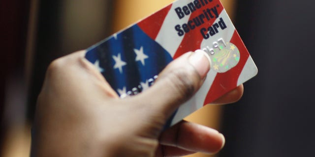NEW YORK - FEBRUARY 10: Kethia Dorelus a social worker with the Cooperative Feeding Program displays a Federal food stamps card that is used to purchase food on February 10, 2011 in Fort Lauderdale, Florida. Recent statistics show that nationwide, one in seven Americans receives help from the Federal government with buying food. The food stamp program was used by 43.6 million people in November 2010. Before the recession, the program was serving 26 million. (Photo by Joe Raedle/Getty Images)