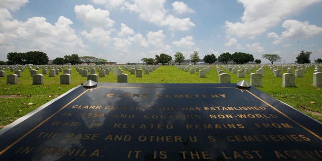 FILE - In this In this July 1, 2011 file photo, a Clark Veterans Cemetery marker faces more than 8,000 tombstones at the sprawling Clark Economic Zone, a former U.S. Air Force base in Dau, Pampanga province in northern Philippines. U.S. and Philippine officials signed an agreement Monday, Dec. 16, 2013, allowing Washington to restore the cemetery where the graves of thousands of American servicemen and dependents have been covered in ash since Mount Pinatubo's 1991 eruption. (AP Photo/Bullit Marquez, File)