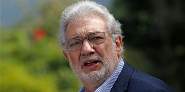 Tenor Placido Domingo gestures after a press conference in Rio de Janeiro, Brazil, Thursday, July 3, 2014. For Placido Domingo, opera and soccer go hand in hand. The Spanish tenor has performed during almost every World Cup since 1990 and plans a July 11 concert in Rio de Janeiro, just two days before the city hosts the final game. (AP Photo/Silvia Izquierdo)