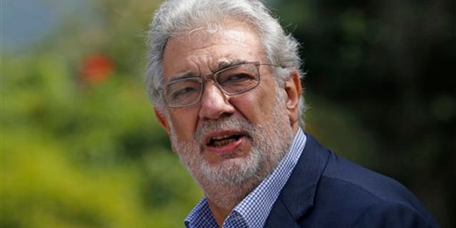 Tenor Placido Domingo gestures after a press conference in Rio de Janeiro, Brazil, Thursday, July 3, 2014. For Placido Domingo, opera and soccer go hand in hand. The Spanish tenor has performed during almost every World Cup since 1990 and plans a July 11 concert in Rio de Janeiro, just two days before the city hosts the final game. (AP Photo/Silvia Izquierdo)