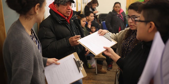 NEW YORK, NY - FEBRUARY 18: Immigrants fill out forms for Deferred Action for Childhood Arrivals (DACA), at a workshop on February 18, 2015 in New York City. The immigrant advocacy group Make the Road New York holds weekly workshops to help immigrants get legal status under DACA to work in the United States. An expansion of the national program, scheduled for this week, was frozen by a ruling from a Texas federal judge. The Obama Administration plans to appeal the ruling and, if sussessful, DACA would allow legalization of up to two million immigrants who entered the United States before they were age 16. (Photo by John Moore/Getty Images)