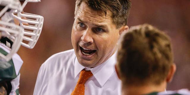 Miami coach Al Golden talks to an unidentified player in the second half of an NCAA college football game against Nebraska in Lincoln, Neb., Saturday, Sept. 20, 2014. Nebraska won 41-31. (AP Photo/Nati Harnik)