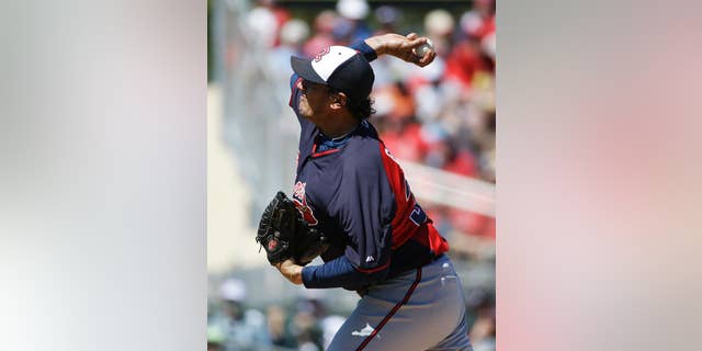 FILE - IN this March 13, 2014 file photo, Atlanta Braves starting pitcher Freddy Garcia plays in an exhibition spring training baseball game against the St. Louis Cardinals in Jupiter, Fla. Former All-Star pitcher Garcia has joined Taiwan's EDA Rhinos and is set to become the highest-paid player in the local league's history.(AP Photo/David Goldman, File)