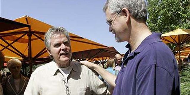 Pastor Jim Garlow from San Diego's evangelical Skyline Church, left, talks with openly gay church member Dean Hughes. (AP)