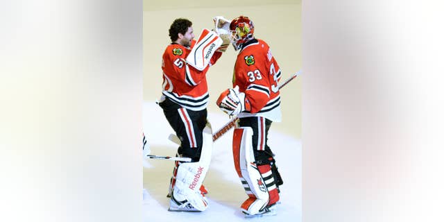 Chicago Blackhawks goalie Corey Crawford, left, congratulates teammate Scott Darling on his 35-save victory over the Nashville Predators in Game 3 of the Western Conference first-round NHL Stanley Cup Playoff series at the United Center in Chicago on Sunday, April 19, 2015. The Blackhawks lead the series 2-1. ( John Starks/Daily Herald via AP) MANDATORY CREDIT; MAGS OUT