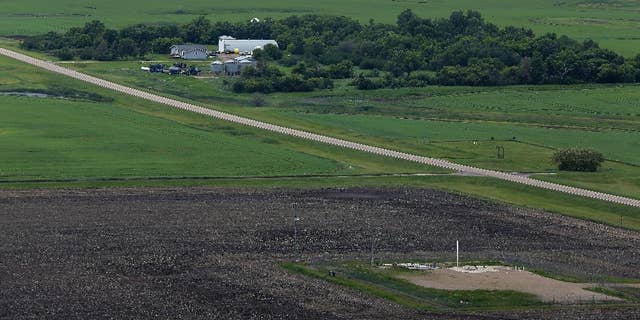 FILE - This June 24, 2014 file photo, shows an ICBM launch site located among fields and farms in the countryside outside Minot, N.D. The Air Force on Monday, Nov. 3, 2014, fired two more nuclear commanders and disciplined a third. The actions were confirmed to the Associated Press in response to an AP inquiry about an internal Air Force investigation of two commanders at the 91st Missile Wing at Minot Air Force Base, N.D., which also is responsible for 150 Minuteman 3 missiles. (AP Photo/Charlie Riedel, File)