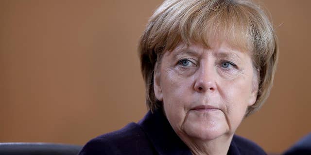 German Chancellor Angela Merkel attends the beginning of the weekly cabinet meeting at the chancellery in Berlin, Germany, Wednesday, Nov. 5, 2014. (AP Photo/Michael Sohn)