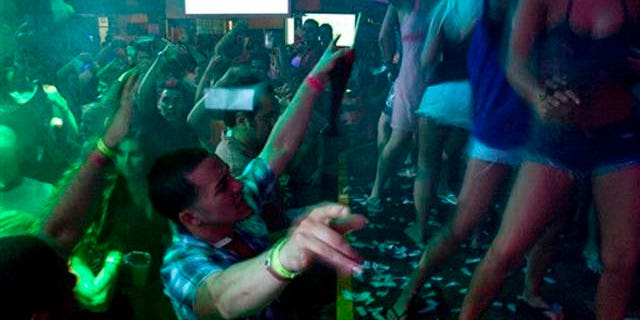 FILE- This Thursday, March 18, 2010 file photo shows spring break revelers as they dance at the Senor Frog's nightclub in Cancun, Mexico. Despite headlines about Mexico's violent drug war, tourism remains relatively strong this year and Cancun is still expecting spring-breakers. (AP Photo/Israel Leal, FILE)