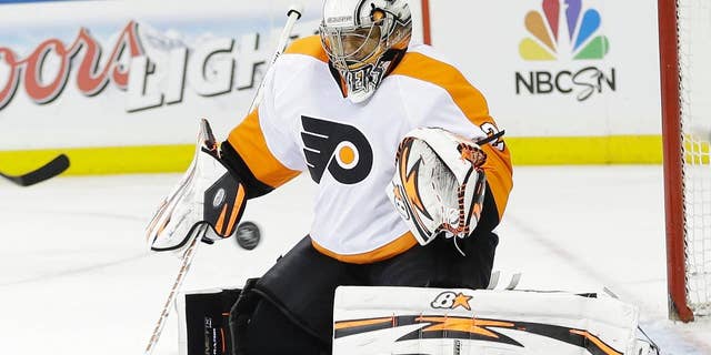 Philadelphia Flyers goalie Ray Emery stops a shot on goal during the second period against the New York Rangers in Game 1 of an NHL hockey first-round playoff series on Thursday, April 17, 2014, in New York. (AP Photo/Frank Franklin II)