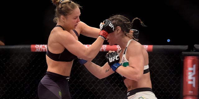In this photo released by Inovafoto, Ronda Rousey, left, of the United States, battles Brazil's Bethe Correia during their mixed martial arts bantamweight title fight at UFC 190, early Sunday, Aug. 2, 2015, in Rio de Janeiro, Brazil. Rousey knocked out Correia 34 seconds into the first round to win. (Alexandre Loureiro/Inovafoto via AP)